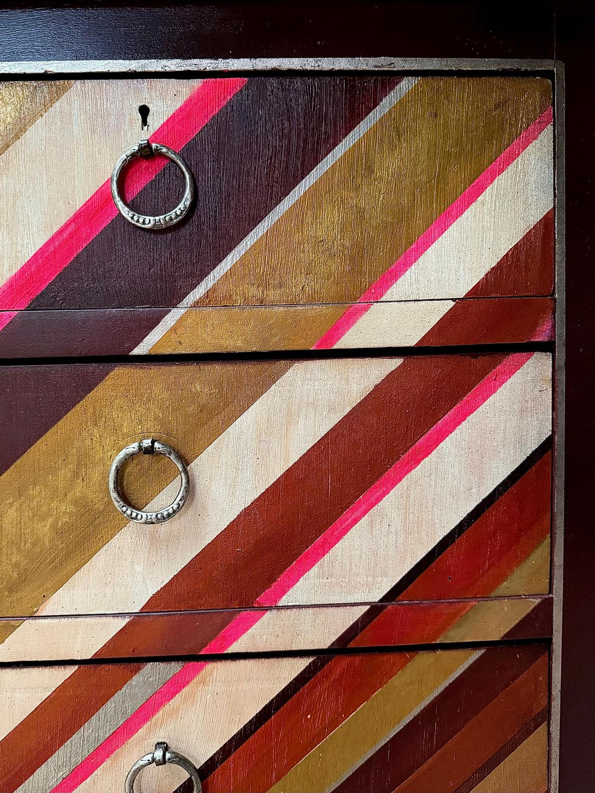 vintage chest of drawers with an asymmetrical painted design by Sarah Parmenter
