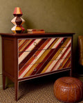 vintage chest of drawers with an asymmetrical painted design by Sarah Parmenter