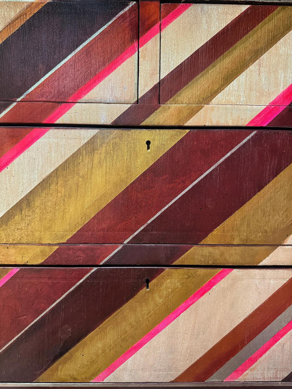 vintage chest of drawers with an asymmetrical painted design by Sarah Parmenter